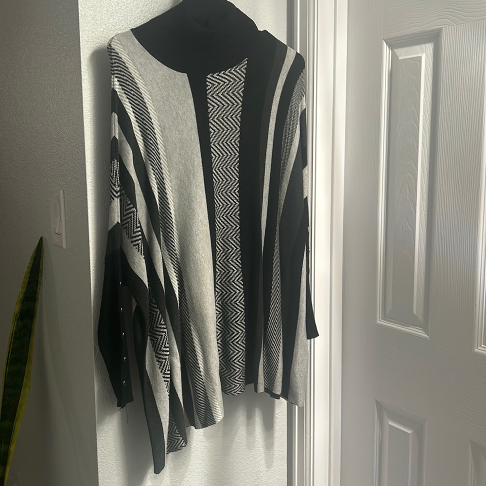 Black and grey oversized poncho with sleeves. Worn once. Like new condition.